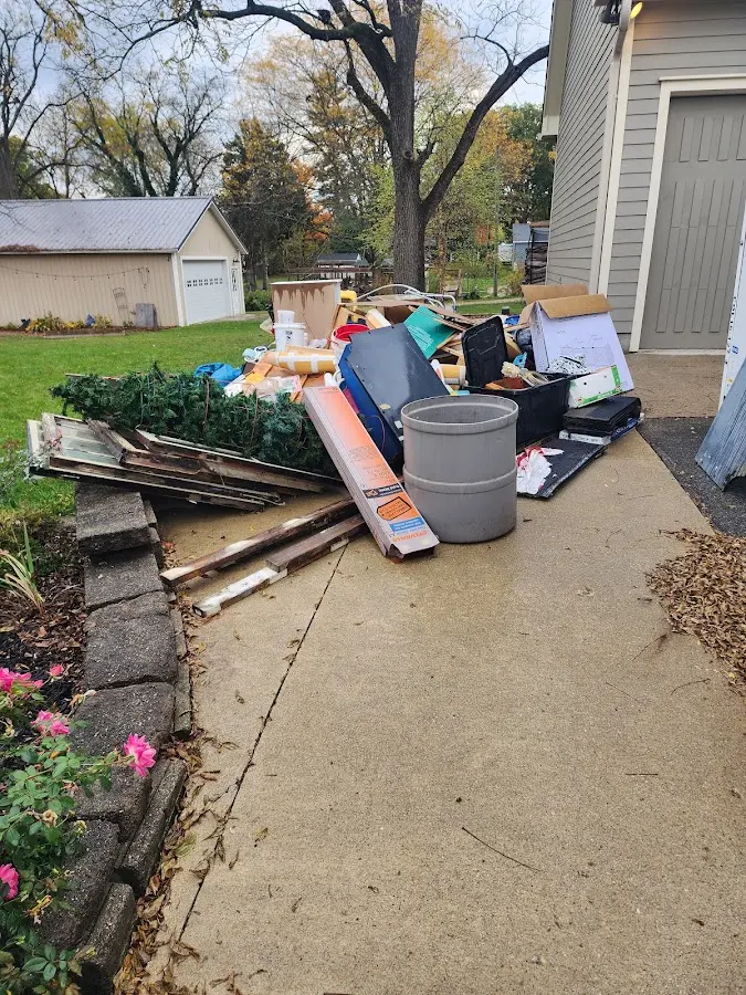 Dumpster being loaded with debris for Residential Dumpster Rental in West Bountiful